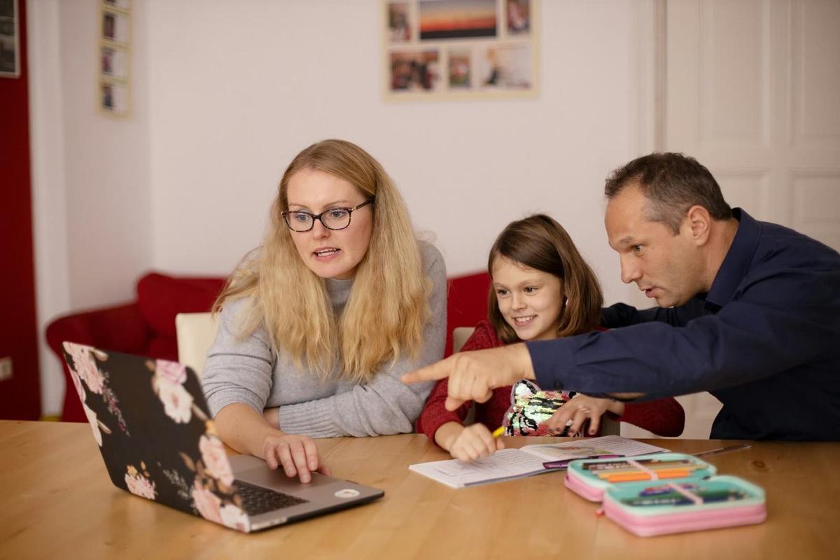 A family planning together at a laptop